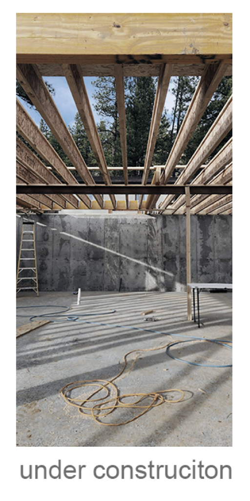 North Fork House — interior framing under open roof with concrete block walls